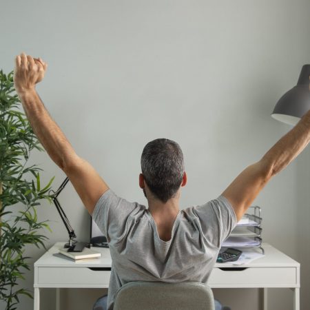 back-view-man-stretching-his-arms-while-working-from-home-scaled.jpg