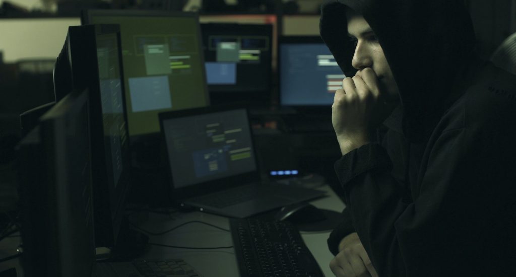 hacker-hiding-in-the-dark-and-working-with-computers.jpg